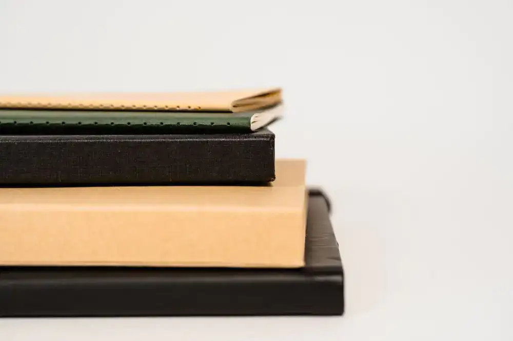 Close up of a hand-stitched leather notebook laying flat on a table