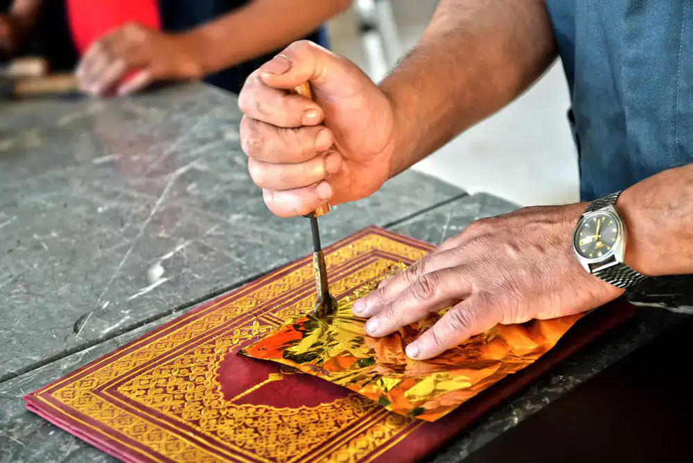 Traditional bookbinding tools on a bench
