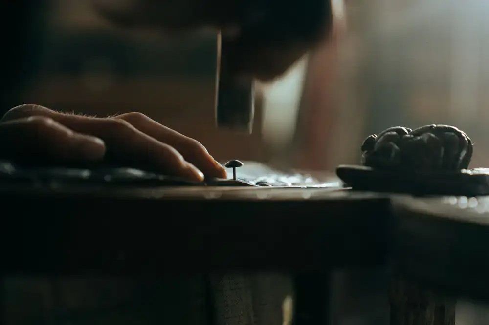 Close up of a restoration artisan gently repairing a torn page with specialized tools
