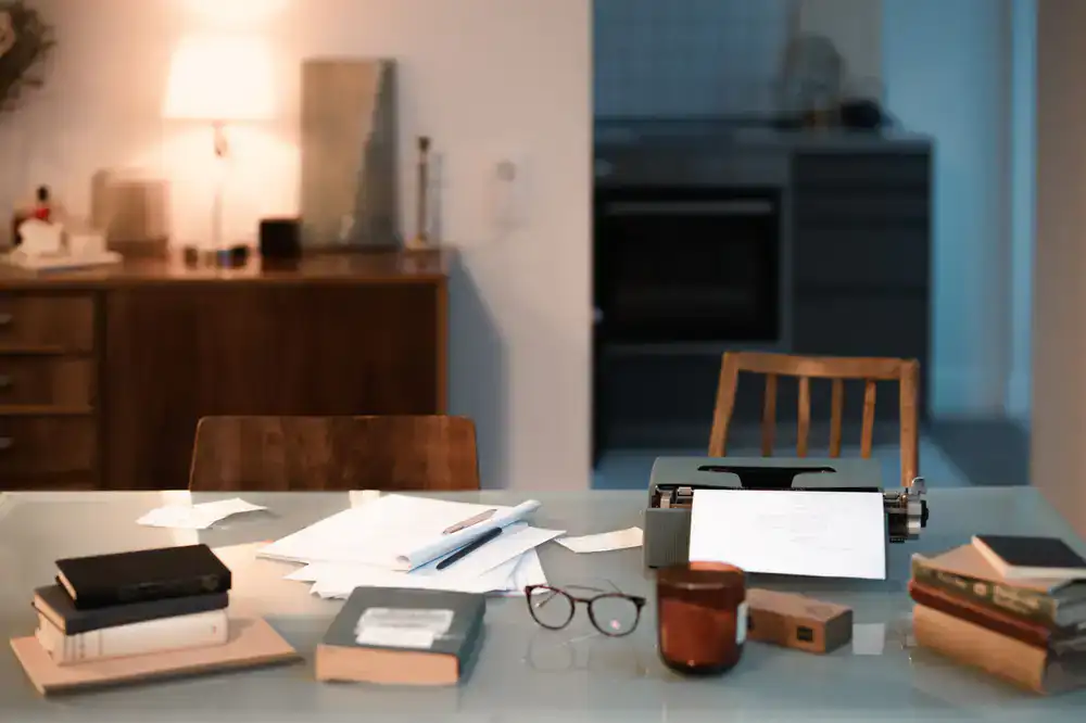 Using delicate tools to mend torn paper under a warm desk lamp