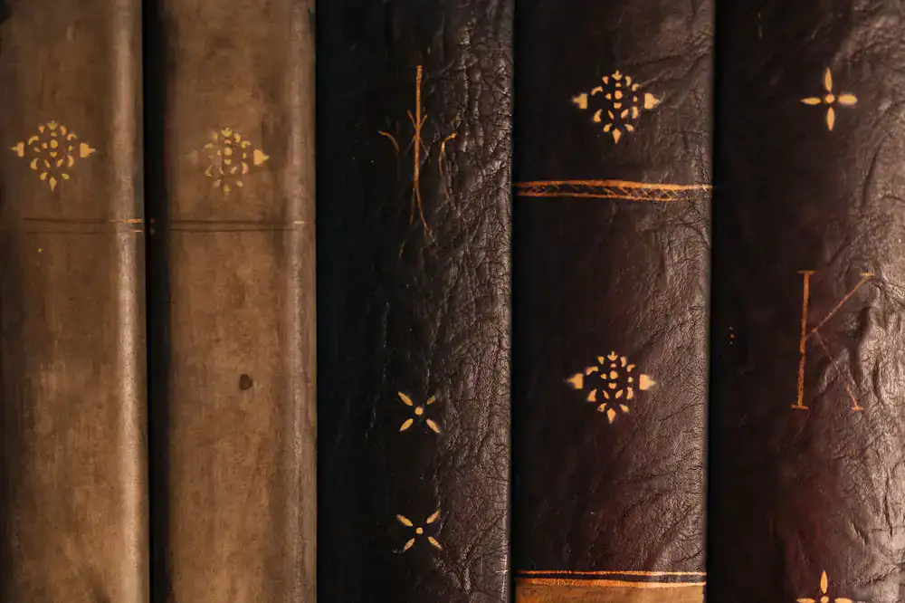 Applying gold leaf tooling to a leather spine